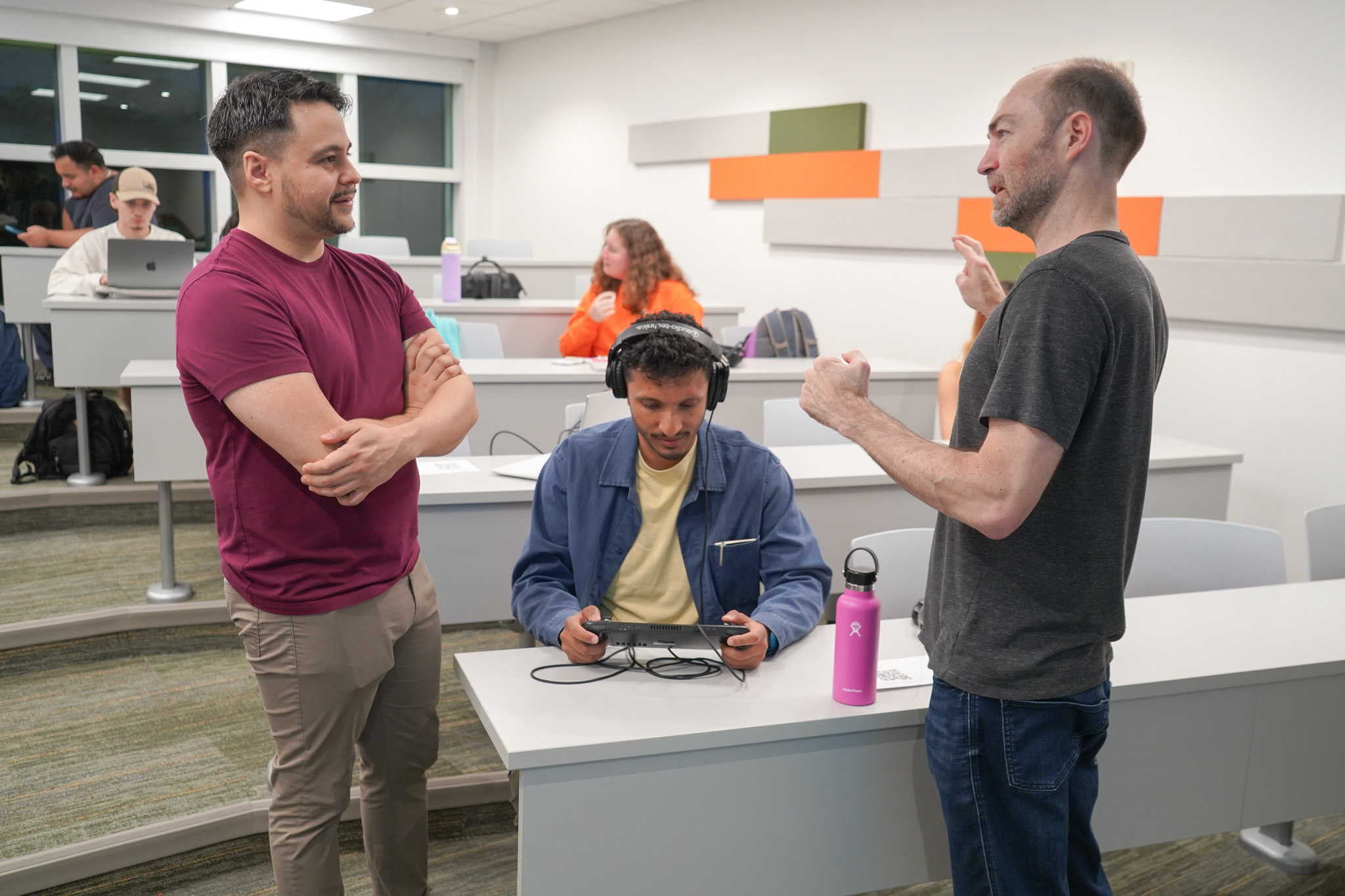 Students gathered around a game station at the NERDLab Arcade