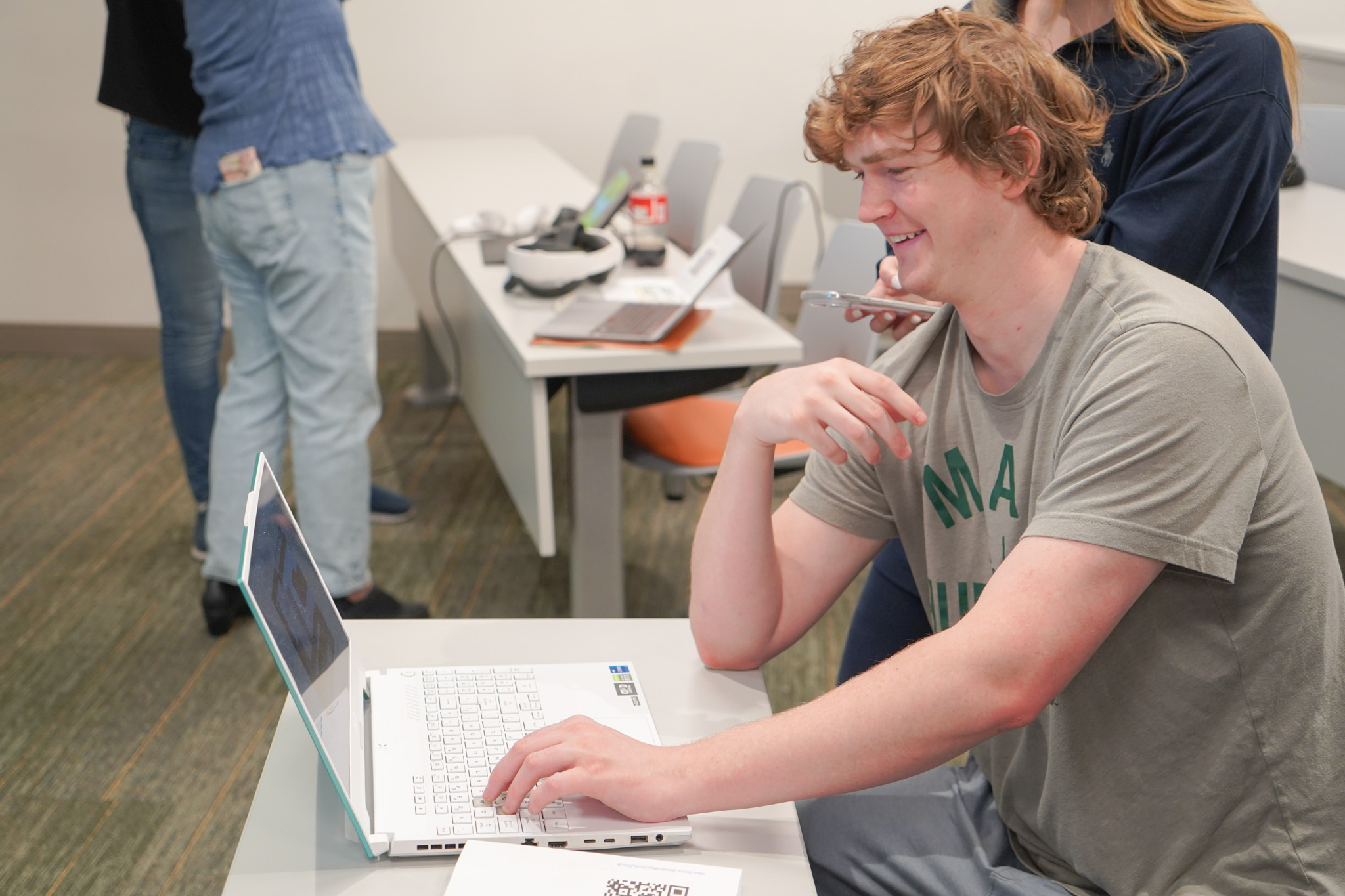 Students gathered in discussion near a game setup
